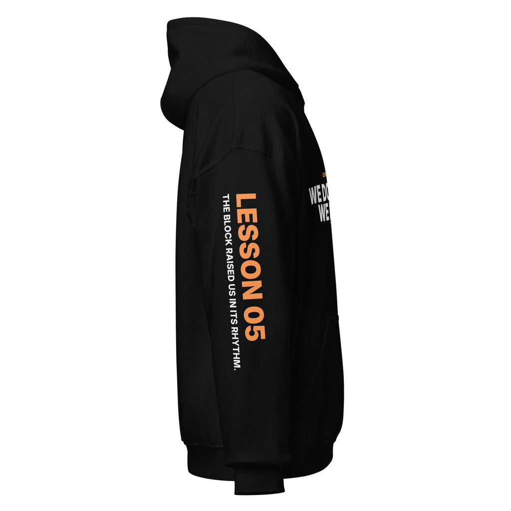 Left sleeve of the black Lesson 05 hoodie, printed with ‘Lesson 05’ in orange and ‘The Block Raised Us in Its Rhythm.’ in white