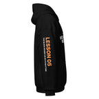 Left sleeve of the black Lesson 05 hoodie, printed with ‘Lesson 05’ in orange and ‘The Block Raised Us in Its Rhythm.’ in white